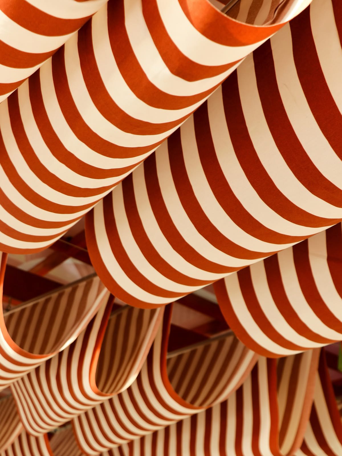 Striped orange and cream awnings, stacked.