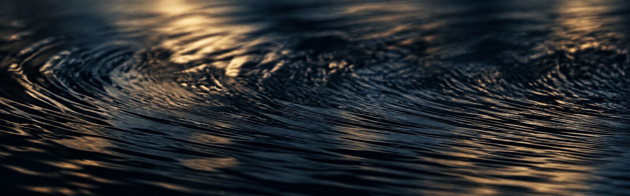 Still water at golden hour, its surface catching the last light.